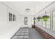 Enclosed porch with charming windows, potted plants, and a smooth transition from indoors to the outside at 2020 N B St, Elwood, IN 46036