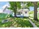 Cozy home featuring a spacious backyard, mature trees, and fire pit providing an ideal retreat at 2136 Ringgold Ave, Indianapolis, IN 46203
