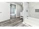 Modern bathroom featuring stylish gray tile, a bathtub, and a sleek white vanity with storage at 2136 Ringgold Ave, Indianapolis, IN 46203