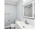 Bathroom with a sleek, lighted mirror, a white vanity, and gray tile at 2136 Ringgold Ave, Indianapolis, IN 46203