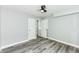 Neutral bedroom with wood-look flooring, featuring a closet and white doors at 2136 Ringgold Ave, Indianapolis, IN 46203