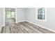 A bright bedroom features gray walls and wood-look floors, complemented by a large window at 2136 Ringgold Ave, Indianapolis, IN 46203