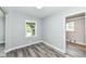Bright bedroom with sleek flooring, fresh paint, and natural light from large windows at 2136 Ringgold Ave, Indianapolis, IN 46203