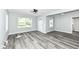 Bright living room with sleek flooring, fresh paint, ceiling fan, and natural light from large windows at 2136 Ringgold Ave, Indianapolis, IN 46203