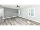 Light-filled living room with modern flooring, a unique accent wall, and neutral paint at 2136 Ringgold Ave, Indianapolis, IN 46203