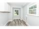 Clean utility room with modern flooring, neutral paint, and ample natural light from the window at 2136 Ringgold Ave, Indianapolis, IN 46203