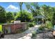 Landscaped backyard featuring a custom brick outdoor kitchen, lovely patio, and charming gazebo with comfortable seating at 2227 Hidden Orchard Ct, Indianapolis, IN 46228