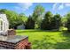 Backyard view showcasing the outdoor kitchen, lush lawn, and a shed, offering space and functionality at 2227 Hidden Orchard Ct, Indianapolis, IN 46228