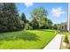 Green backyard featuring mature trees and lush green grass at 2227 Hidden Orchard Ct, Indianapolis, IN 46228