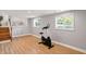 Finished basement with wood look floors, access to stairway, and a stationary bike for in-home fitness at 2227 Hidden Orchard Ct, Indianapolis, IN 46228