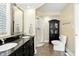 Bathroom featuring a glass enclosed shower, a vanity with double sinks, and dark cabinets at 2227 Hidden Orchard Ct, Indianapolis, IN 46228