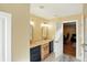 Bright bathroom with double sinks, each with its own mirror and vanity, and an open doorway to another room at 2227 Hidden Orchard Ct, Indianapolis, IN 46228