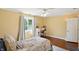 Bedroom with hardwood floors, a ceiling fan, and a window providing bright natural light at 2227 Hidden Orchard Ct, Indianapolis, IN 46228