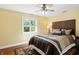 Comfortable bedroom featuring a ceiling fan and a large window for natural light and cozy decor at 2227 Hidden Orchard Ct, Indianapolis, IN 46228