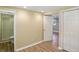Bedroom with neutral walls, wood flooring, a closet, and an en-suite bathroom featuring a glass enclosed shower at 2227 Hidden Orchard Ct, Indianapolis, IN 46228