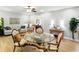 Bright dining room with a glass table, ceiling fan, and hardwood floors at 2227 Hidden Orchard Ct, Indianapolis, IN 46228
