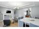 Bright dining area features a stylish light fixture, wood floors, and access to staircase with a decorative railing at 2227 Hidden Orchard Ct, Indianapolis, IN 46228