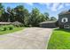 Long concrete driveway leading to the detached three-car garage and a brick home at 2227 Hidden Orchard Ct, Indianapolis, IN 46228