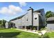 Rear exterior view of a gray two-story home featuring well-maintained landscaping at 2227 Hidden Orchard Ct, Indianapolis, IN 46228