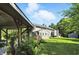 Exterior view featuring the gazebo, brick outdoor kitchen, well-maintained lawn, and the back of the house at 2227 Hidden Orchard Ct, Indianapolis, IN 46228