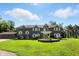 A lavish home featuring a well-manicured lawn, decorative fountain, and a three-car garage at 2227 Hidden Orchard Ct, Indianapolis, IN 46228