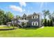 Two-story home with well-manicured lawn, fountain, and lush green landscape at 2227 Hidden Orchard Ct, Indianapolis, IN 46228