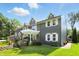 Side angle of a luxury home with well-maintained landscaping and elegant architectural details at 2227 Hidden Orchard Ct, Indianapolis, IN 46228