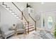Bright foyer featuring a staircase with wood and white railings and gray marble floors at 2227 Hidden Orchard Ct, Indianapolis, IN 46228