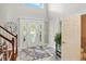 Bright foyer showcasing a decorative front door, marble floors, and a staircase at 2227 Hidden Orchard Ct, Indianapolis, IN 46228