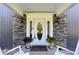 Elegant front door with decorative glass, stone accents, and potted flowers at 2227 Hidden Orchard Ct, Indianapolis, IN 46228