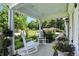 Inviting front porch with white rocking chairs and decorative potted plants at 2227 Hidden Orchard Ct, Indianapolis, IN 46228