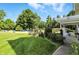 Inviting front yard with mature shade trees and a charming front porch with rocking chairs at 2227 Hidden Orchard Ct, Indianapolis, IN 46228