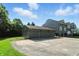 Spacious three car garage with an ample concrete driveway providing lots of parking at 2227 Hidden Orchard Ct, Indianapolis, IN 46228