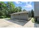 Spacious three-car garage with ample parking space and well-maintained surroundings at 2227 Hidden Orchard Ct, Indianapolis, IN 46228