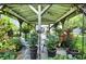 Serene gazebo featuring comfortable seating, string lights, and views of the beautifully landscaped backyard at 2227 Hidden Orchard Ct, Indianapolis, IN 46228