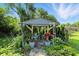 Charming gazebo surrounded by lush landscaping, providing a serene outdoor retreat with comfortable seating at 2227 Hidden Orchard Ct, Indianapolis, IN 46228