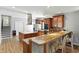Bright open kitchen boasts granite countertops, stainless steel appliances, and hardwood floors at 2227 Hidden Orchard Ct, Indianapolis, IN 46228