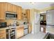 Cozy kitchen featuring wooden cabinets, stainless steel appliances, and an open doorway to another room at 2227 Hidden Orchard Ct, Indianapolis, IN 46228