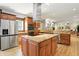 Open concept kitchen with island, stainless steel appliances, granite countertops, and breakfast bar at 2227 Hidden Orchard Ct, Indianapolis, IN 46228