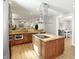 Open kitchen with stainless appliances, granite counters and island with a view to the living area at 2227 Hidden Orchard Ct, Indianapolis, IN 46228