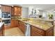 Kitchen features stainless appliances, granite countertops, hardwood floors and ample cabinet space at 2227 Hidden Orchard Ct, Indianapolis, IN 46228