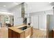 Modern kitchen with a stainless steel vent hood, center island, granite countertops, and ample storage at 2227 Hidden Orchard Ct, Indianapolis, IN 46228