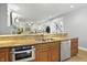 Open kitchen with stainless steel appliances, granite countertops, and a view to the living room at 2227 Hidden Orchard Ct, Indianapolis, IN 46228