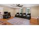 Cozy living room featuring hardwood floors, comfortable seating, and natural light from multiple windows at 2227 Hidden Orchard Ct, Indianapolis, IN 46228