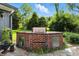 Custom brick outdoor kitchen with stainless steel doors and granite countertops, perfect for entertaining at 2227 Hidden Orchard Ct, Indianapolis, IN 46228