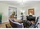 Cozy music room with a piano and a view to another room at 2227 Hidden Orchard Ct, Indianapolis, IN 46228