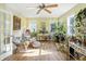 Bright sunroom with lots of natural light, hardwood flooring and lots of windows, plants and decor at 2227 Hidden Orchard Ct, Indianapolis, IN 46228