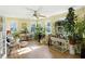Sunroom filled with plants, natural light, ceiling fan and hardwood flooring at 2227 Hidden Orchard Ct, Indianapolis, IN 46228
