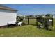 Large backyard featuring black metal fence, lush green lawn, and lounge chairs for entertaining at 2232 Warbler St, Danville, IN 46122