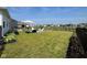 Spacious backyard featuring a black fence, outdoor furniture, green grass, and an umbrella for shaded relaxation at 2232 Warbler St, Danville, IN 46122